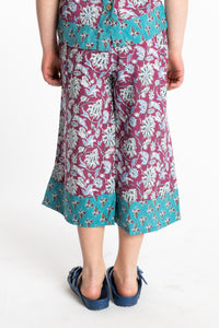 Louisa age 7 wearing Penny Lane Contrast Hem Kids Pants in burgundy floral print, size Small