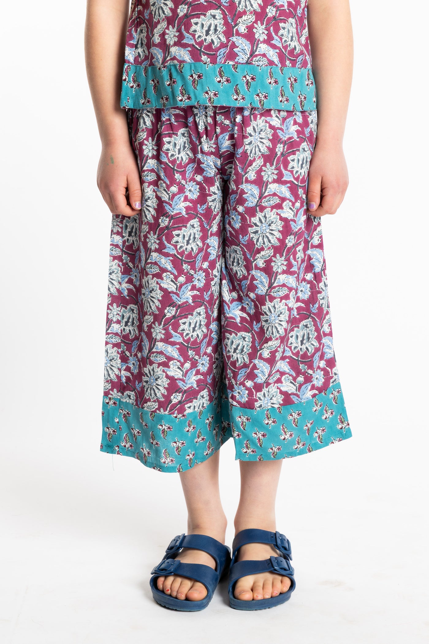 Louisa age 7 wearing Penny Lane Contrast Hem Kids Pants in burgundy floral print, size Small