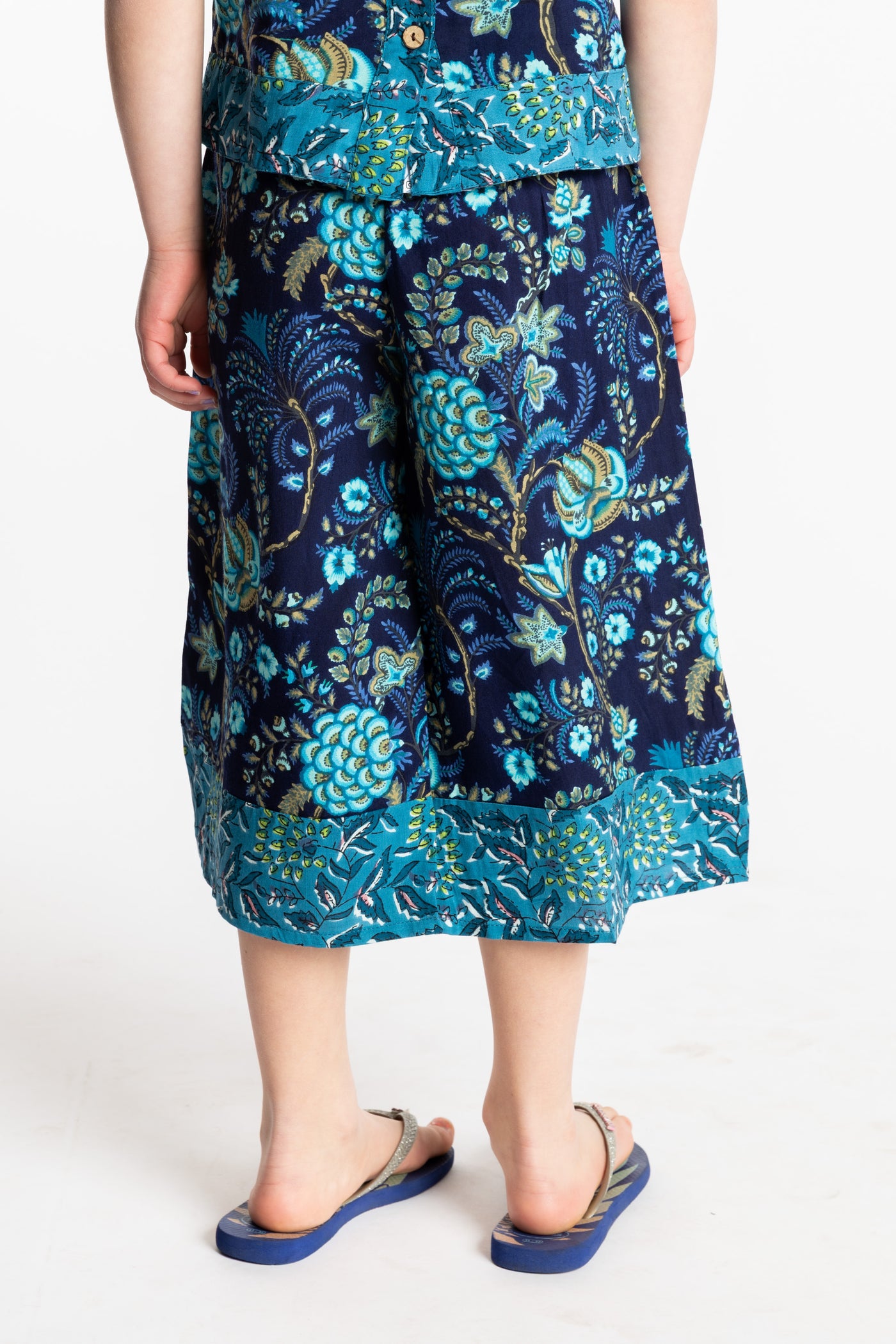 Louisa age 7 wearing Penny Lane Contrast Hem Kids Pants in navy floral print, size Small