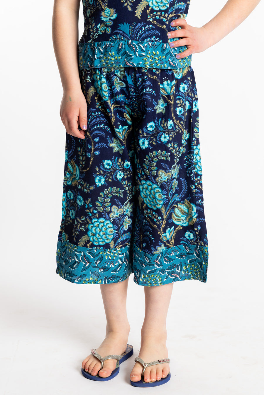 Louisa age 7 wearing Penny Lane Contrast Hem Kids Pants in navy floral print, size Small