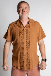 Chris, 5'7", wearing the Chandani Cotton Button Up in orange brown, size M