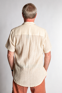 Chris, 5'7", wearing the Chandani Cotton Button Up in ivory white, size M