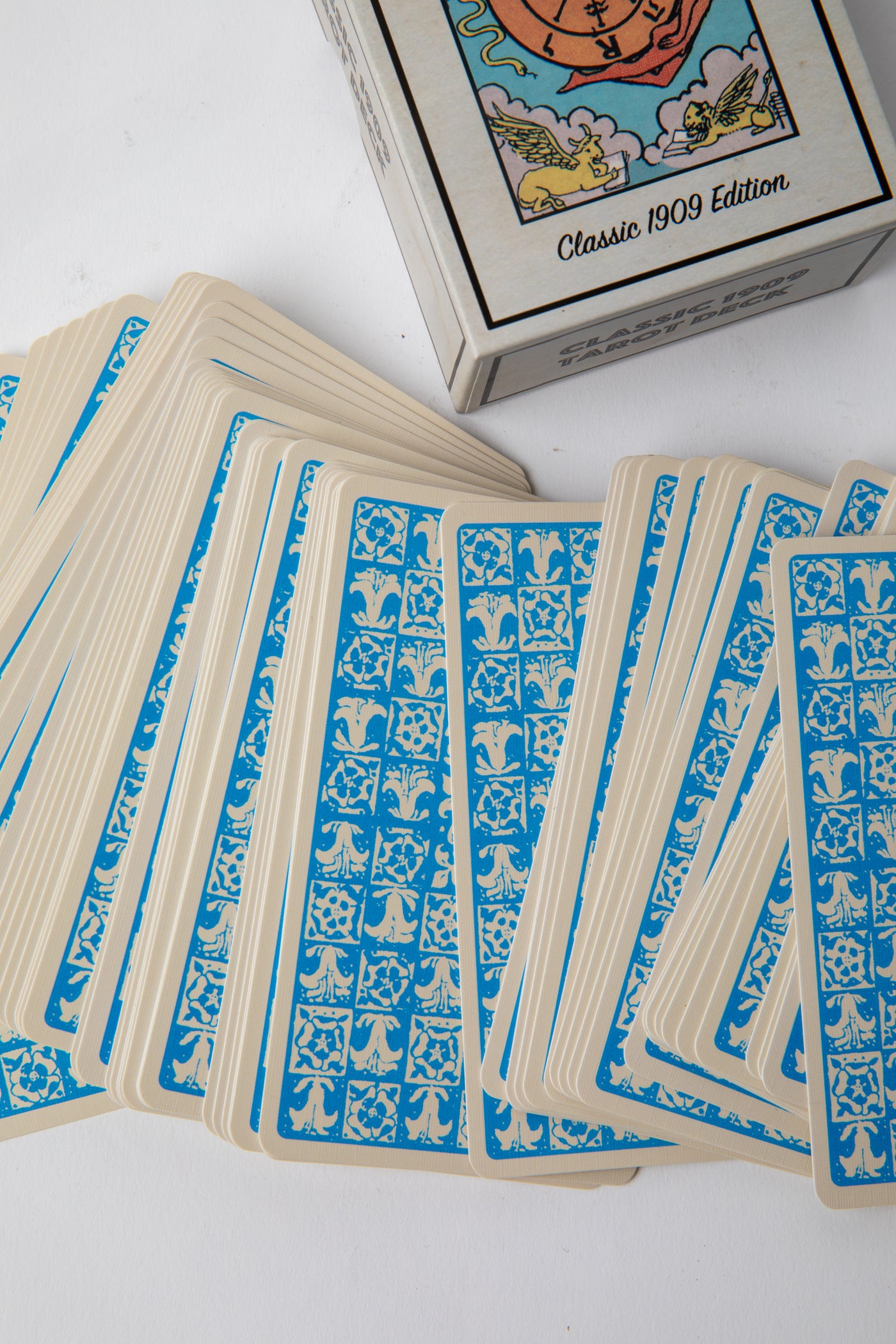 Fan of Classic 1909 Tarot Deck cards showing intricate Pamela Colman Smith illustrations and vibrant vintage colors