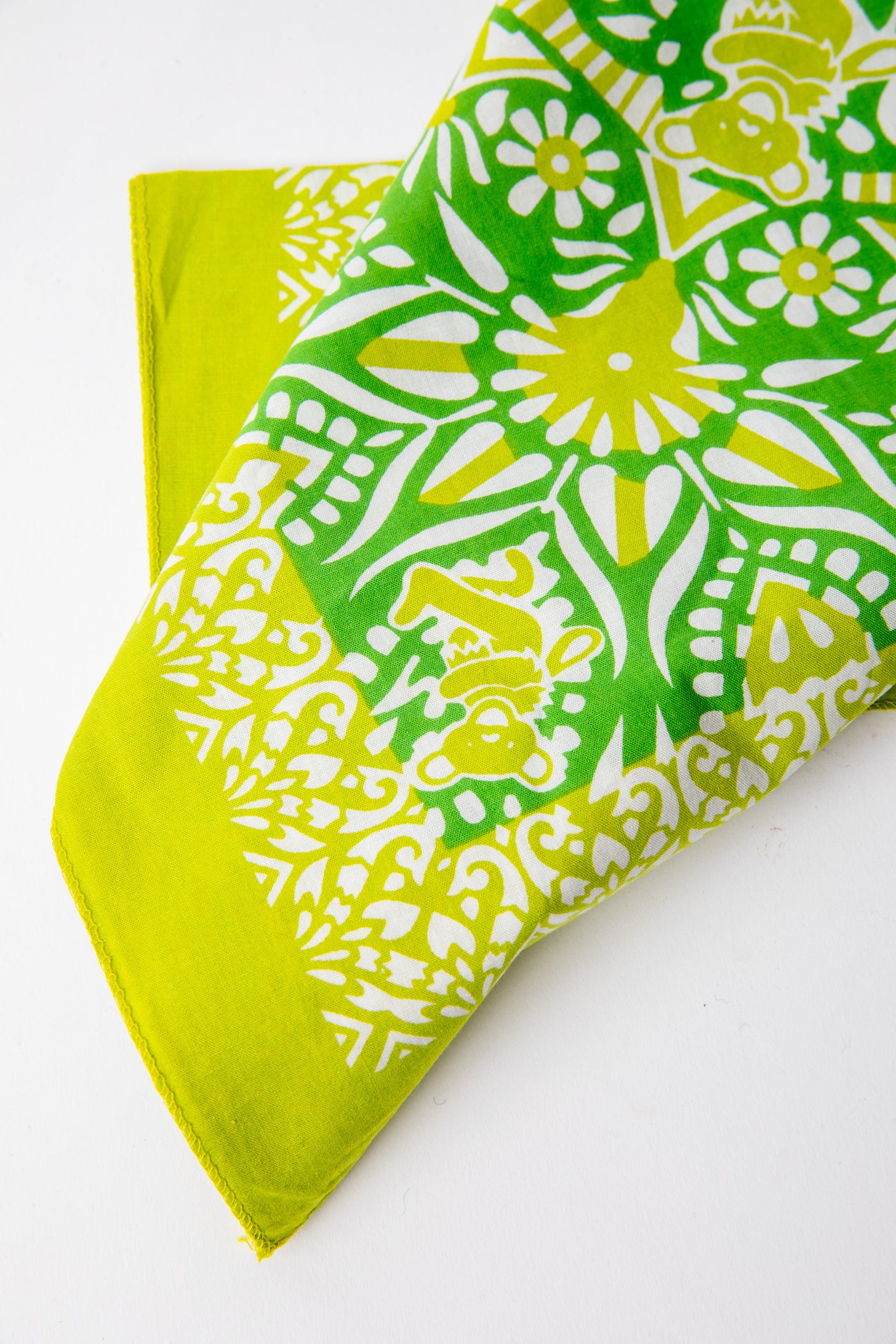 Folded green and yellow Grateful Dead bandana showing mandala design and iconic Dancing Bears