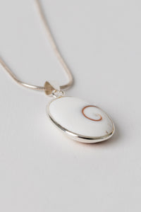 Sterling Shiva eye pendant with natural shell spiral pattern