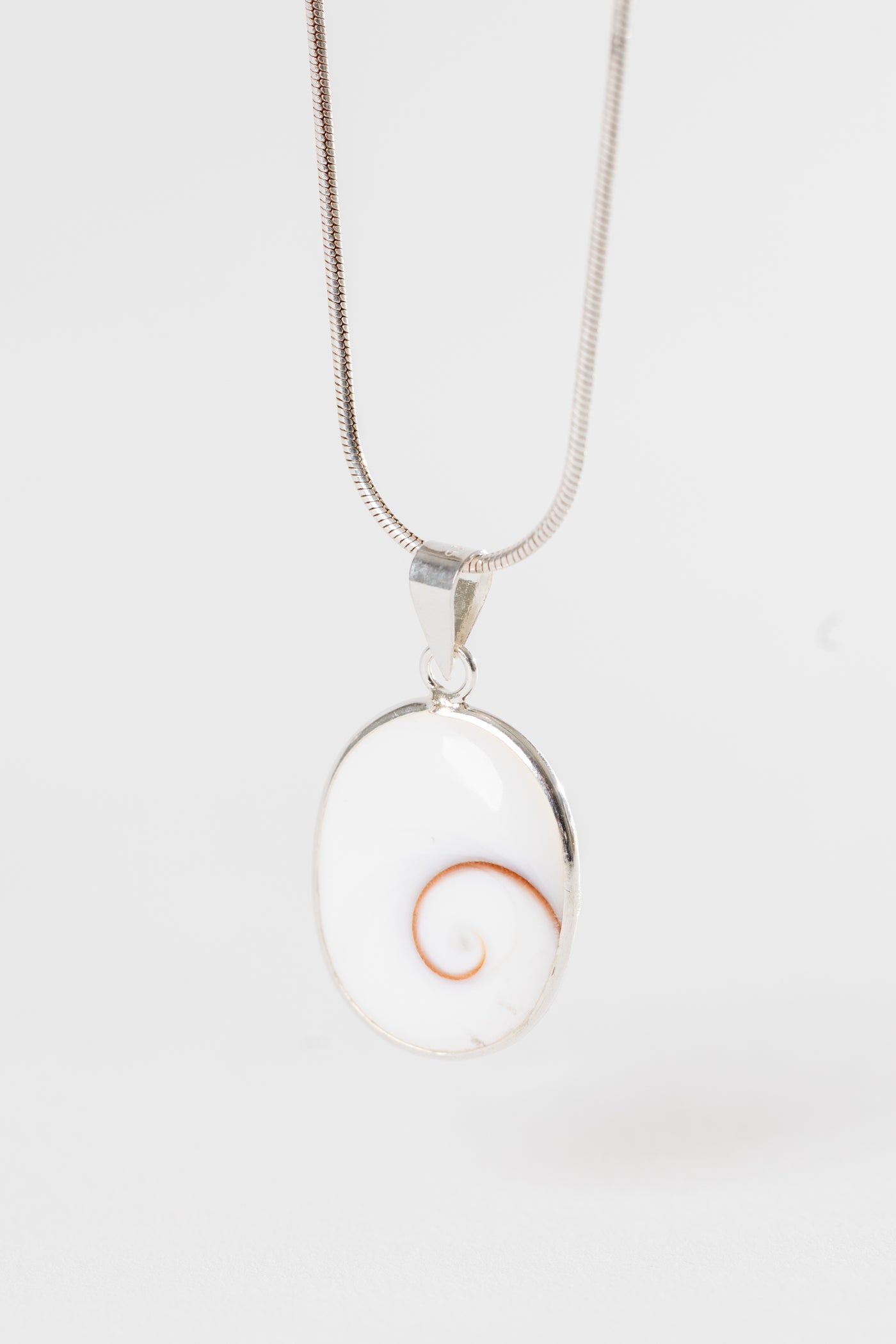 Sterling Shiva eye pendant with natural shell spiral pattern