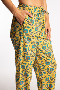 Sophie is wearing the yellow floral Morning Glory Jaipur Printed Pajama Set in S/M