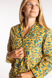 Sophie is wearing the yellow floral Morning Glory Jaipur Printed Pajama Set in S/M