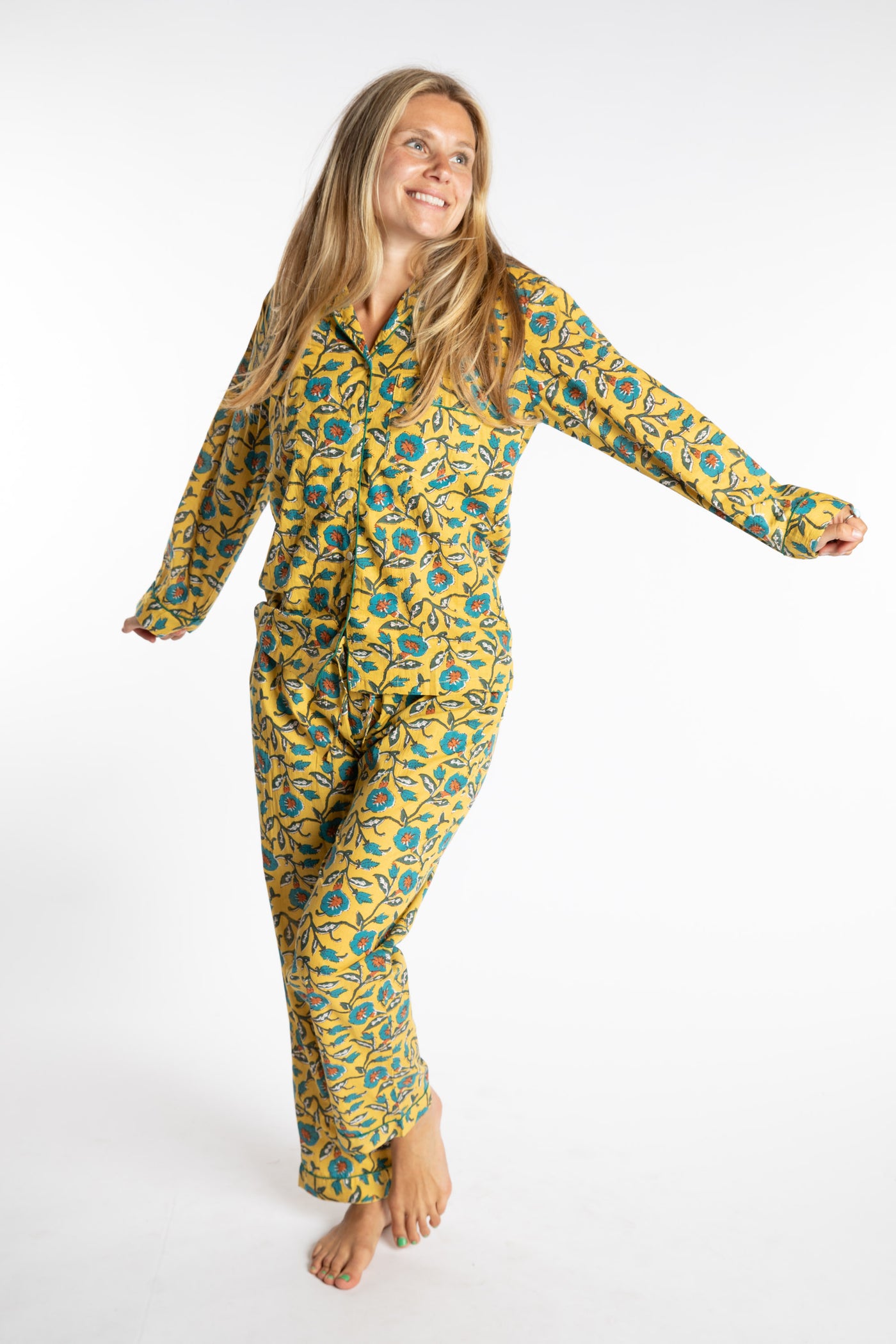 Sophie is wearing the yellow floral Morning Glory Jaipur Printed Pajama Set in S/M