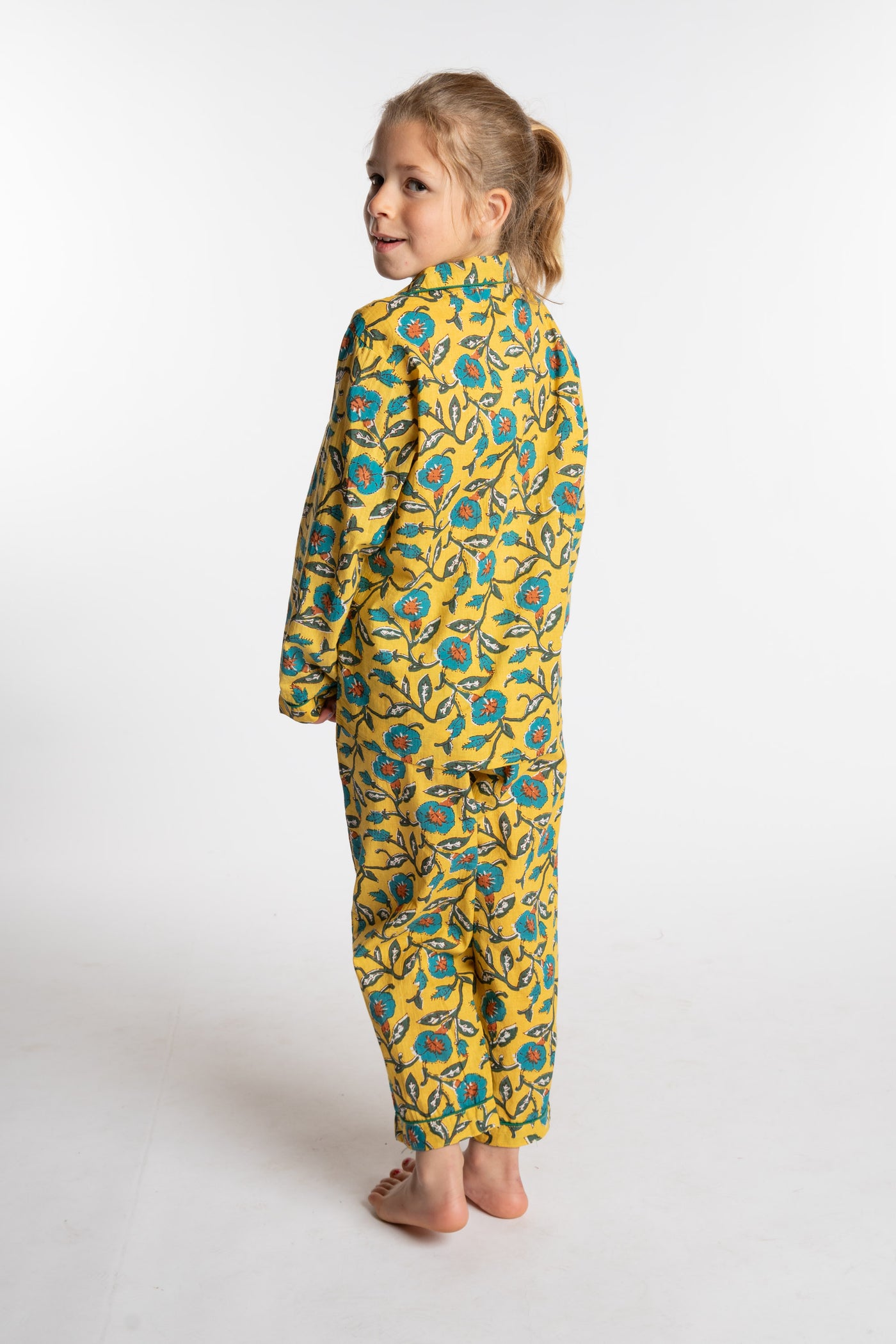 Louisa, age 7, wearing the size 4/5 Kids Jaipur Printed Pajama Set in Yellow Floral Morning Glory
