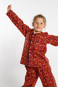 Louisa, age 7, wearing the size 4/5 Kids Jaipur Printed Pajama Set in Red Floral Pomegranate.