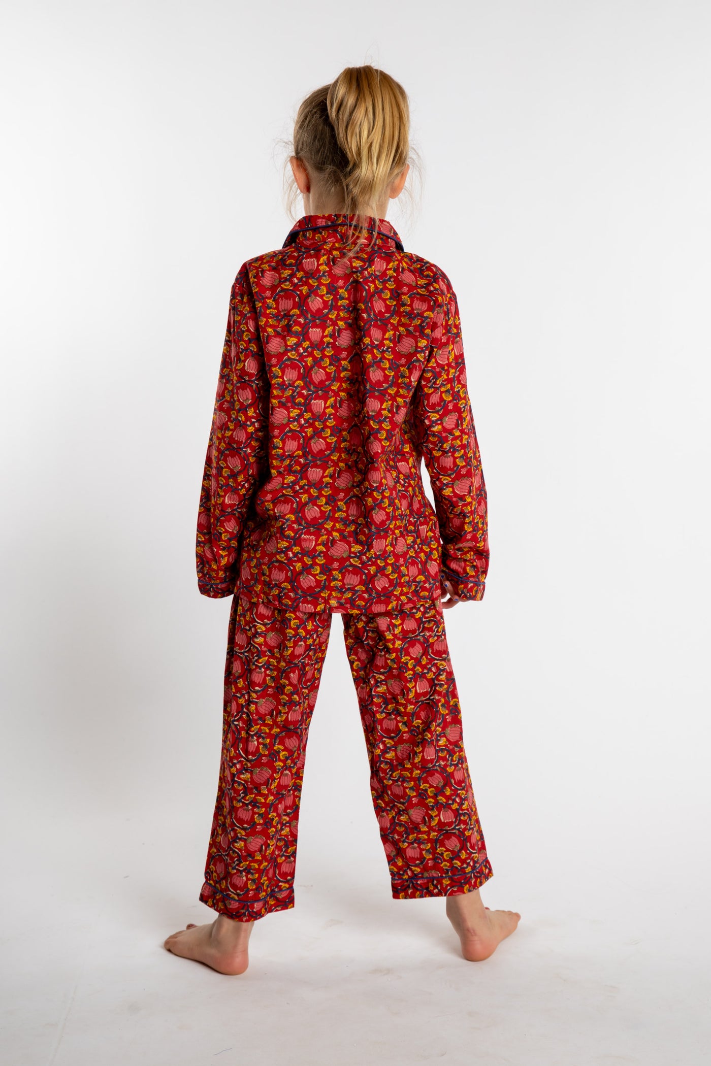 Louisa, age 7, wearing the size 4/5 Kids Jaipur Printed Pajama Set in Red Floral Pomegranate.