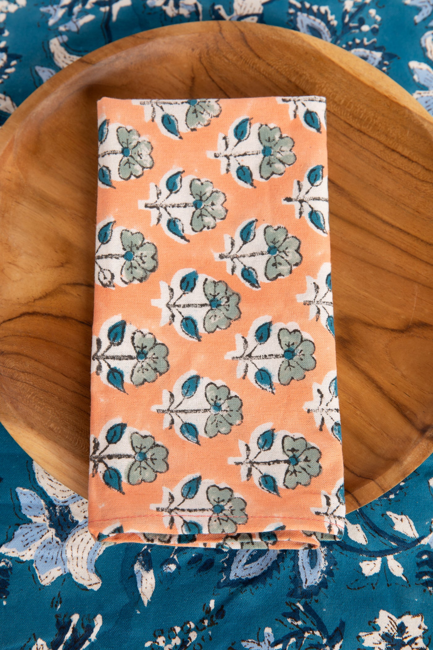 Dusty Coral floral block print napkin on teak plate and block print placemat