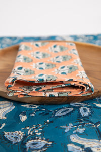 Dusty Coral floral block print napkin on teak plate and block print placemat