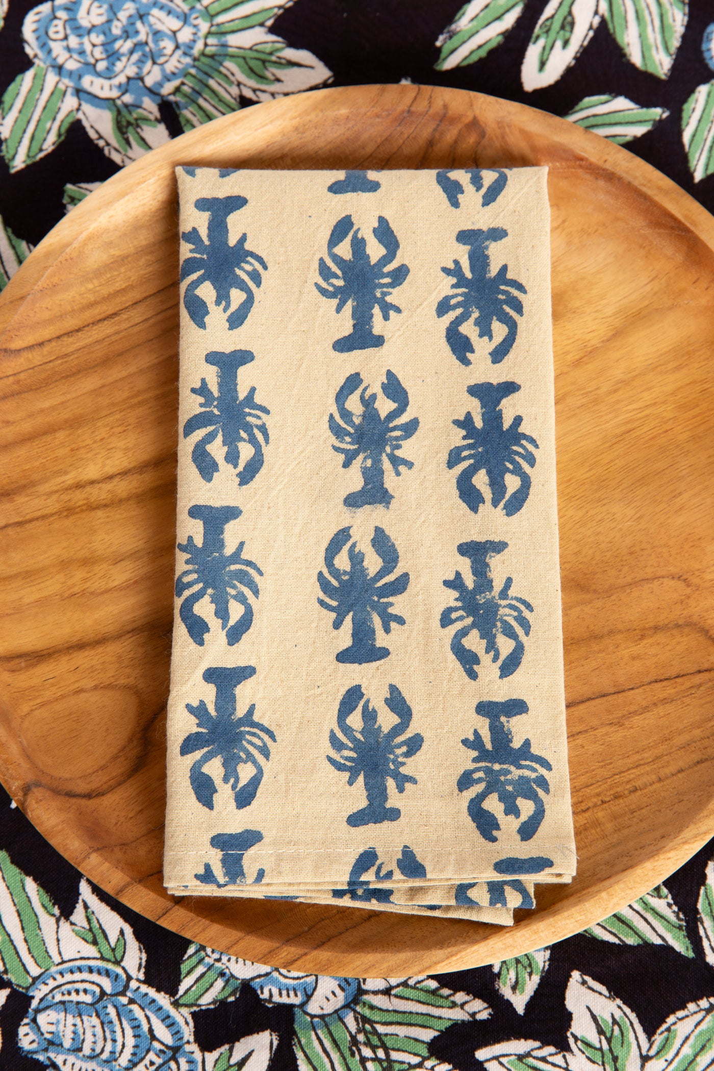 Blue Lobster block print napkin on teak plate and block print placemat