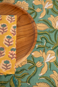 Aquamarine floral block print placemat under teak plate and block print napkin 