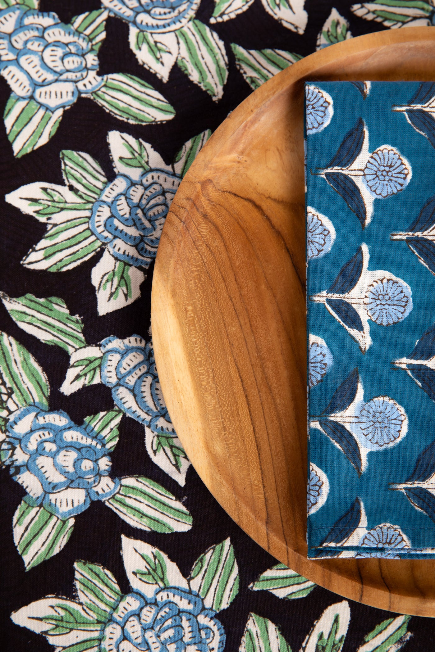 Black floral block print placemat under teak plate and block print napkin 