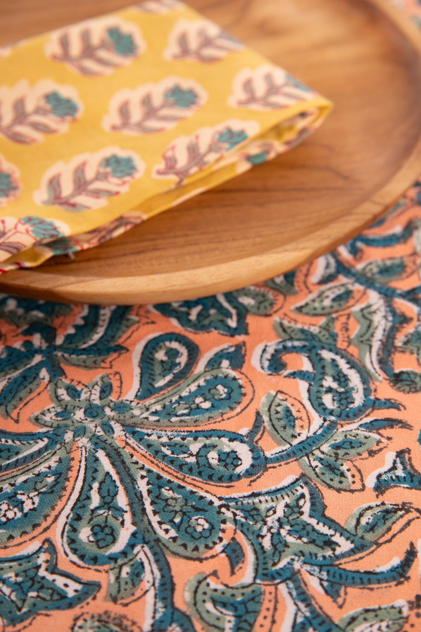 Dusty Coral floral block print placemat under teak plate and block print napkin 