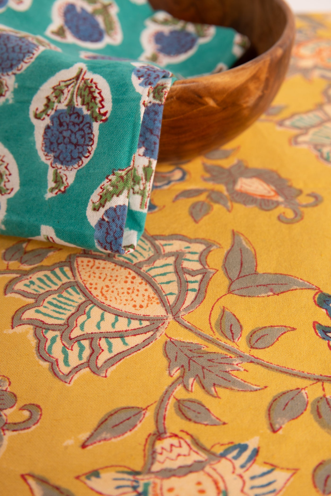 Marigold Yellow floral block print placemat under teak bowl and block print napkin 