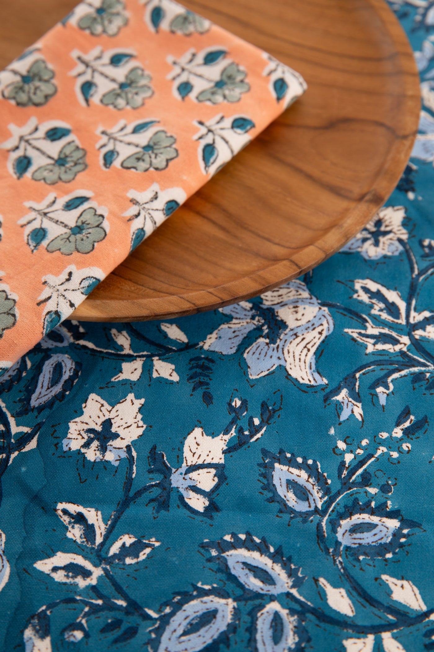 Storm Blue floral block print placemat under teak plate and block print napkin 