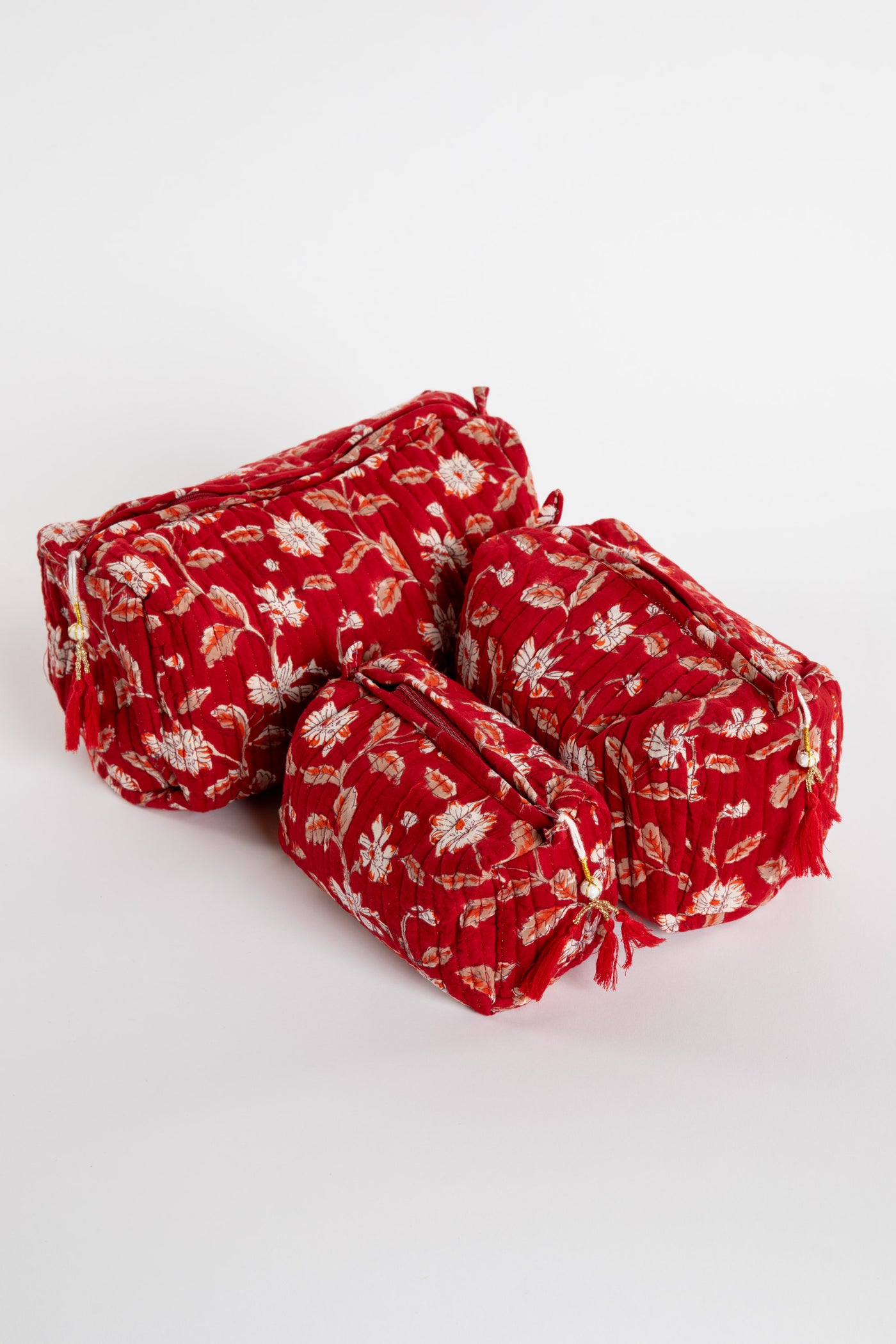 Quilted block print bag in red Garnet floral. Available in 3 sizes.