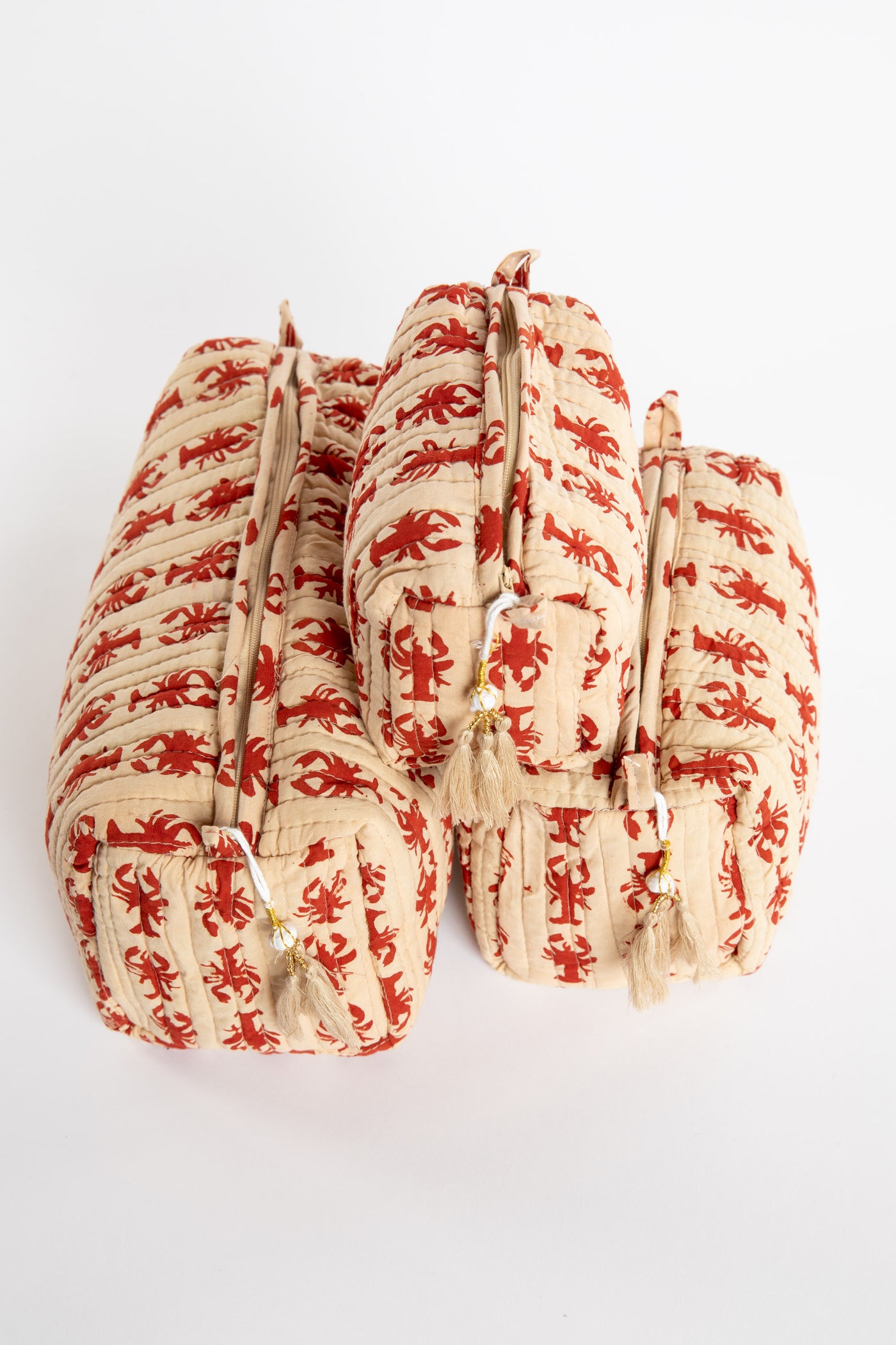 Quilted block print bag in red lobster. Available in 3 sizes.