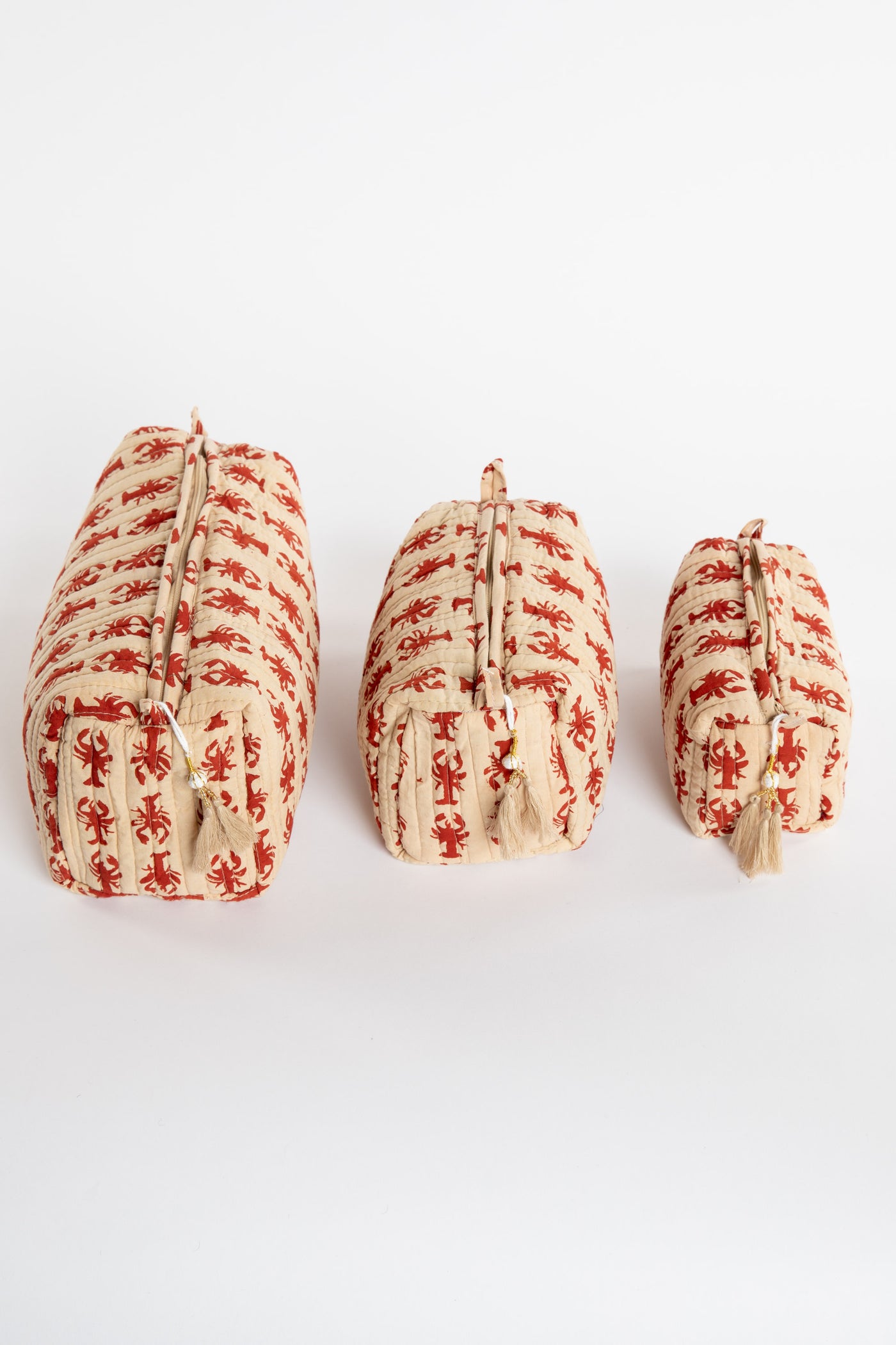Quilted block print bag in red lobster. Available in 3 sizes.