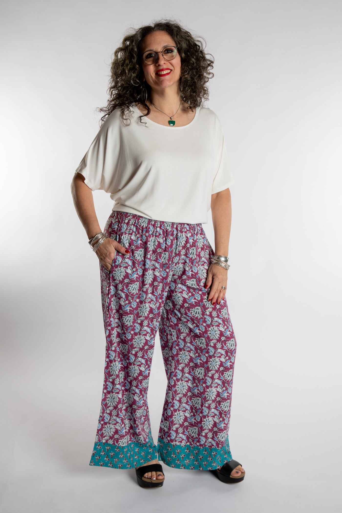 Susan is wearing the Allie Dolman shirt L/XL in white and the Burgundy Penny Lane Contrast Pants in M/L
