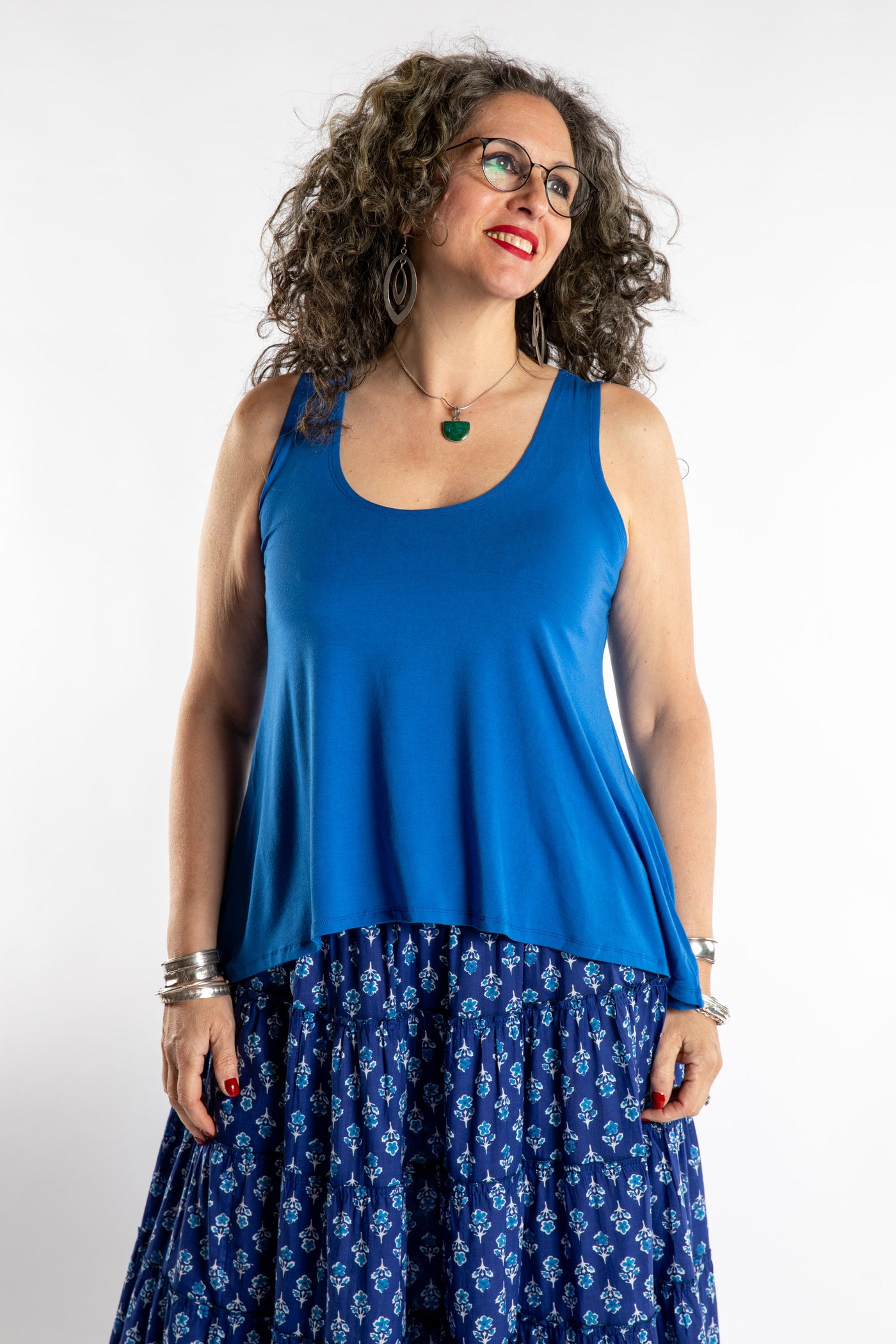 Susan is wearing the Ahana Flow Tank in Blueberry