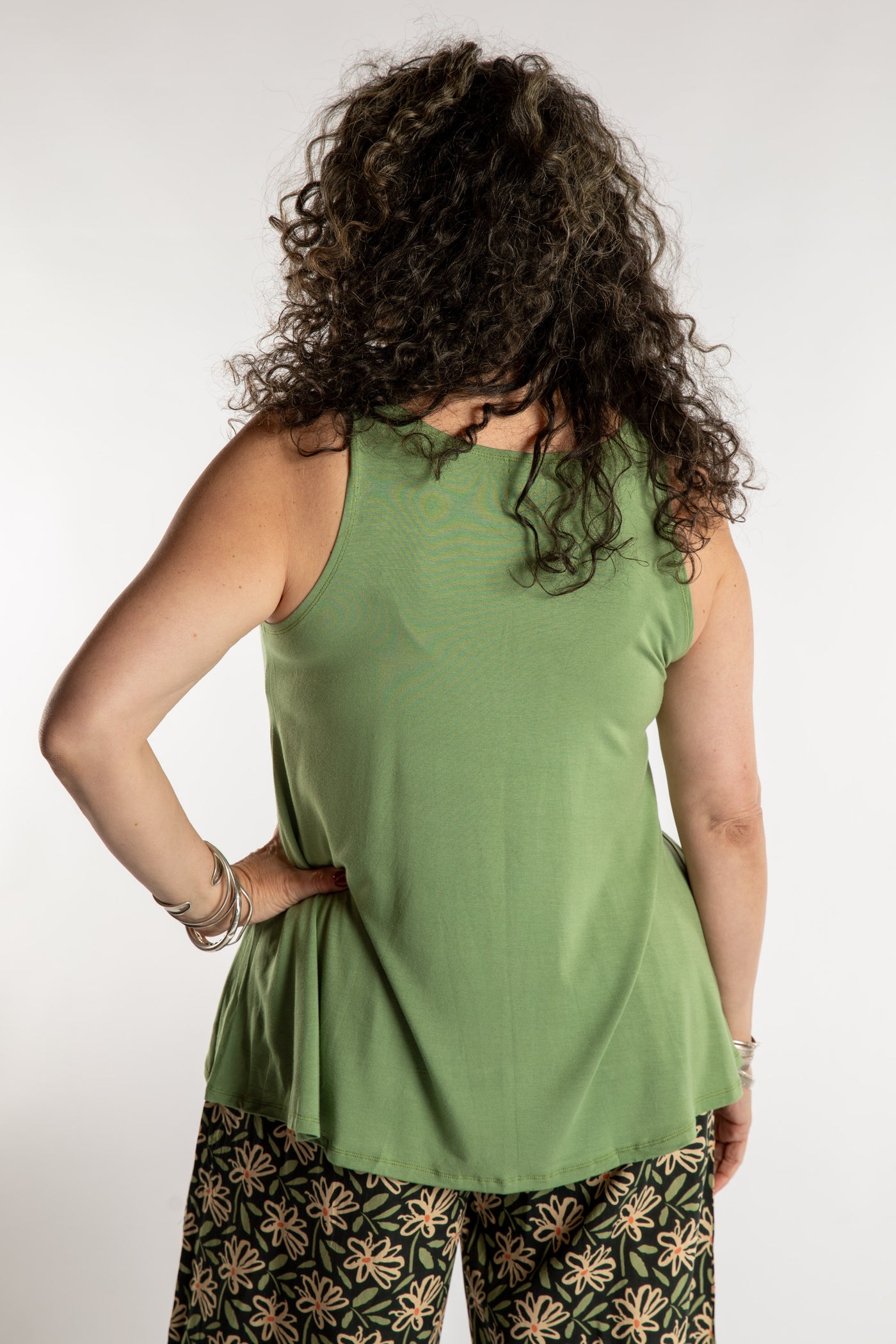 Susan is wearing the Ahana Flow Tank in Light Green