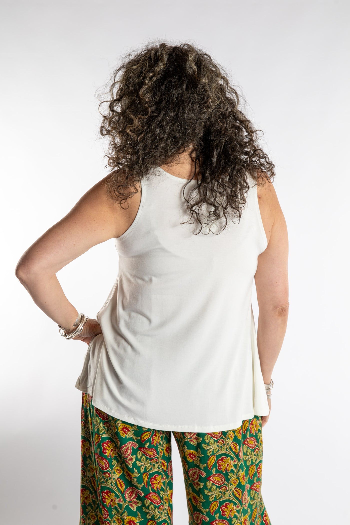 Susan is wearing the Ahana Flow Tank in White