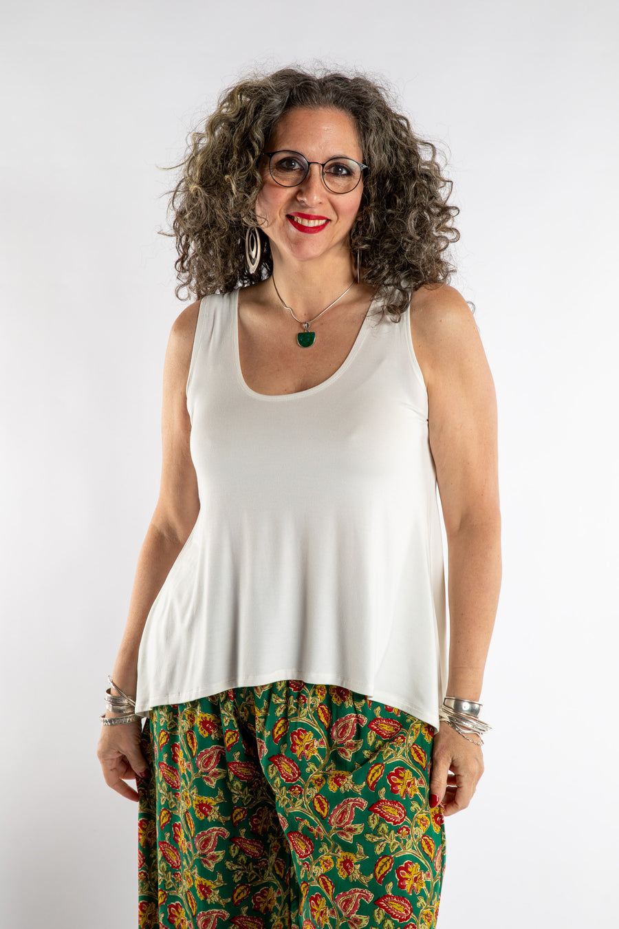 Susan is wearing the Ahana Flow Tank in White