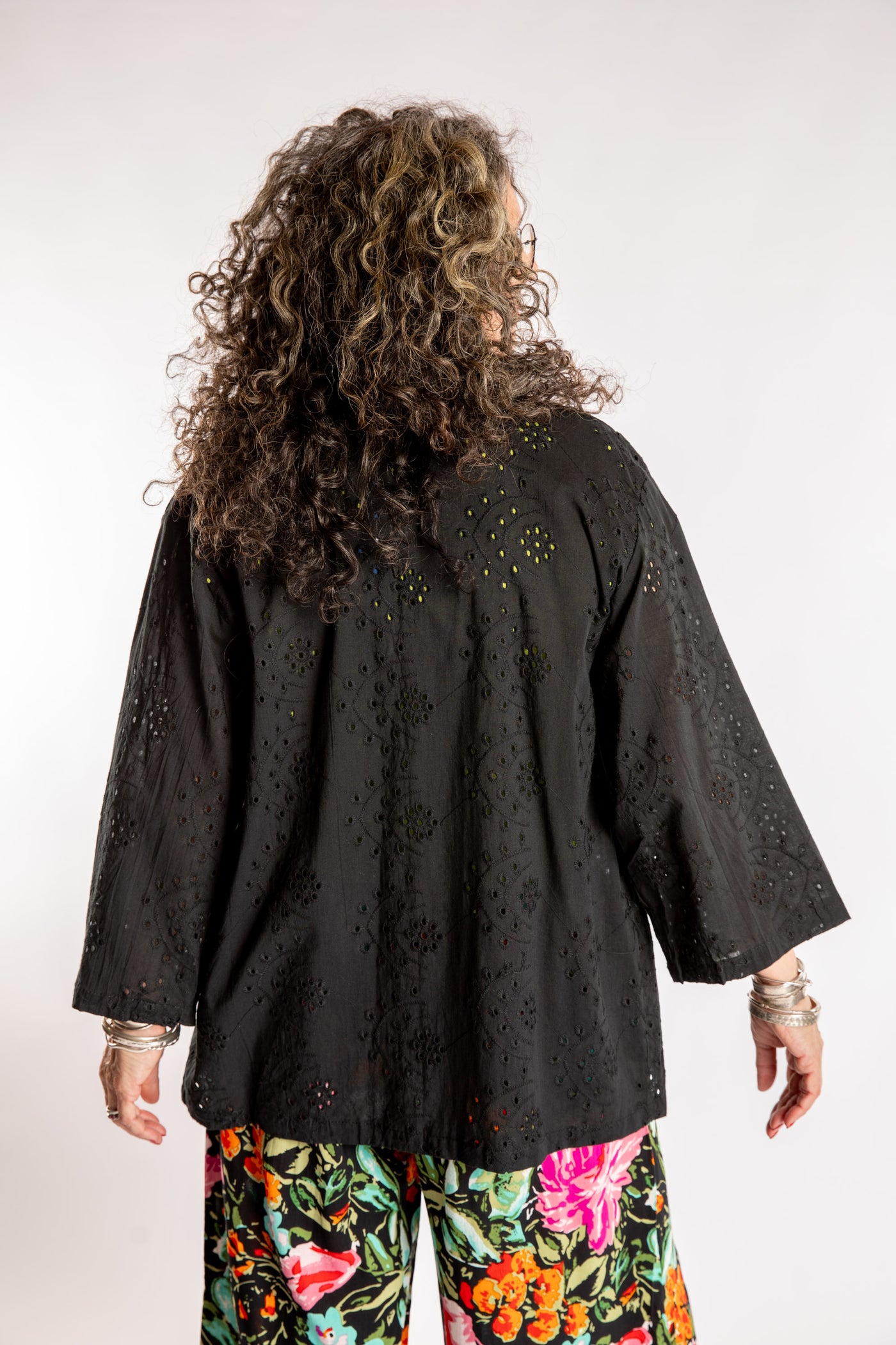 Susan is wearing the one size Anandi cardigan in Black
