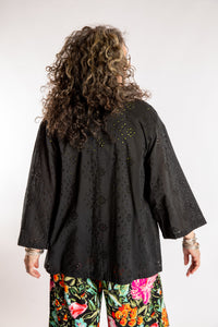 Susan is wearing the one size Anandi cardigan in Black