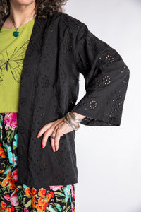 Susan is wearing the one size Anandi cardigan in Black