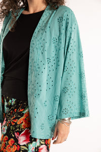 Susan is wearing the one size Anandi cardigan in Seafoam