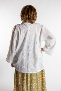Betty is wearing the one size Anandi cardigan in White
