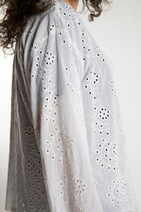 Susan is wearing the one size Anandi cardigan in White
