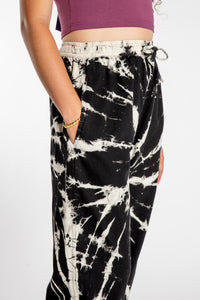 Emily is wearing the Black Anika Tie Dye Jogger Pants in S/M