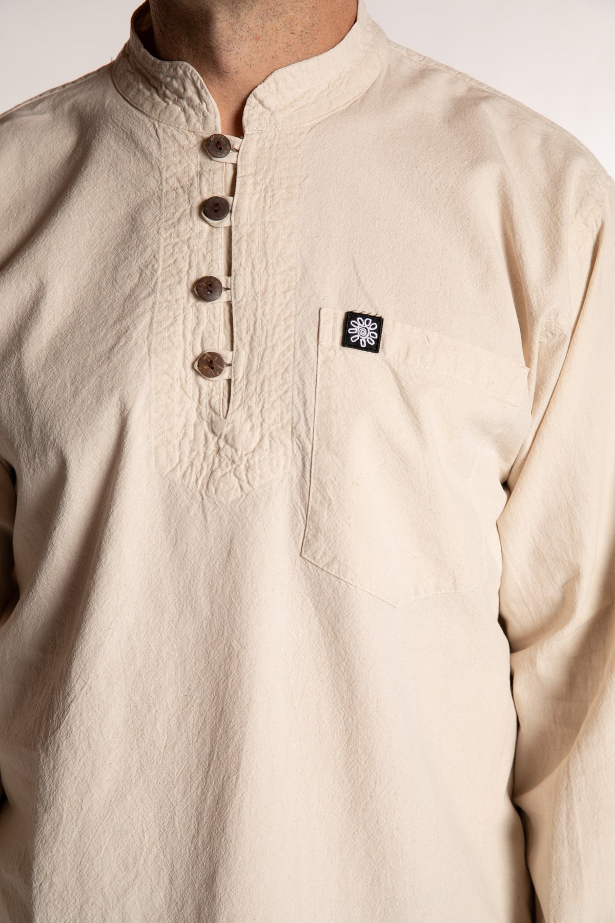 Topher is wearing the Large Arun Band Collar Cotton Shirt in Ivory