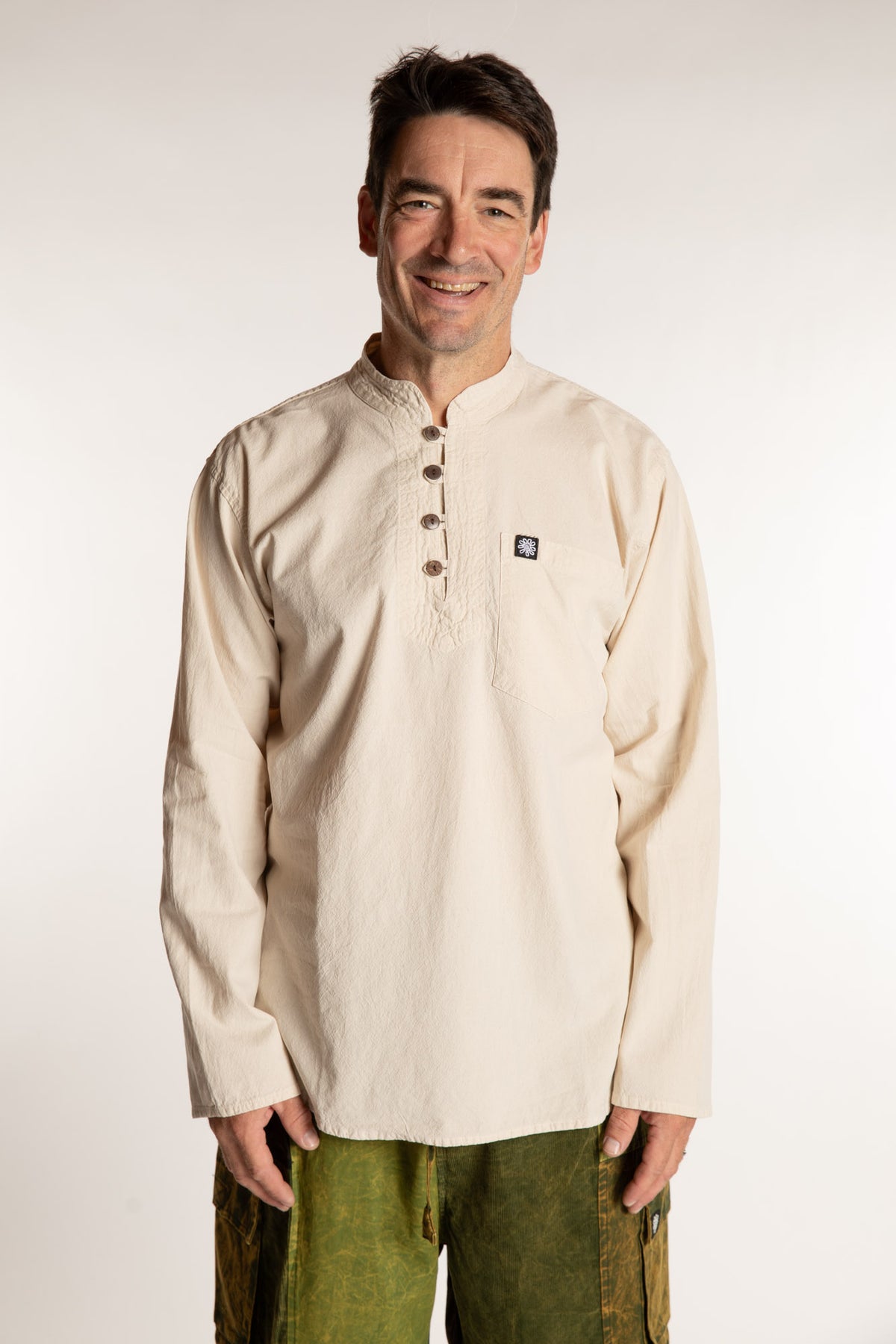 Topher is wearing the Large Arun Band Collar Cotton Shirt in Ivory