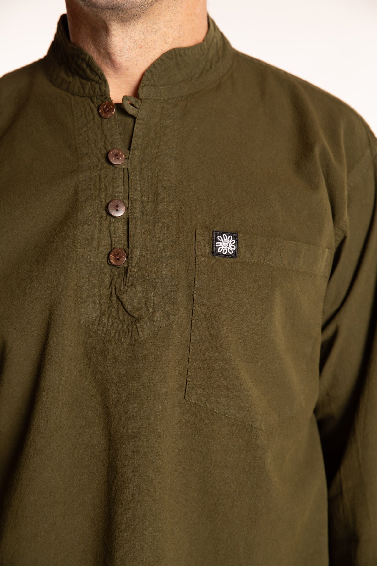Topher is wearing the Large Arun Band Collar Cotton Shirt in Olive