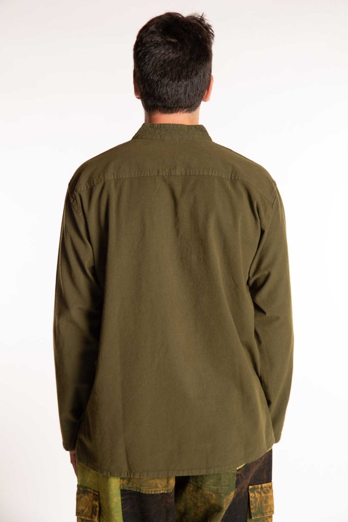 Topher is wearing the Large Arun Band Collar Cotton Shirt in Olive