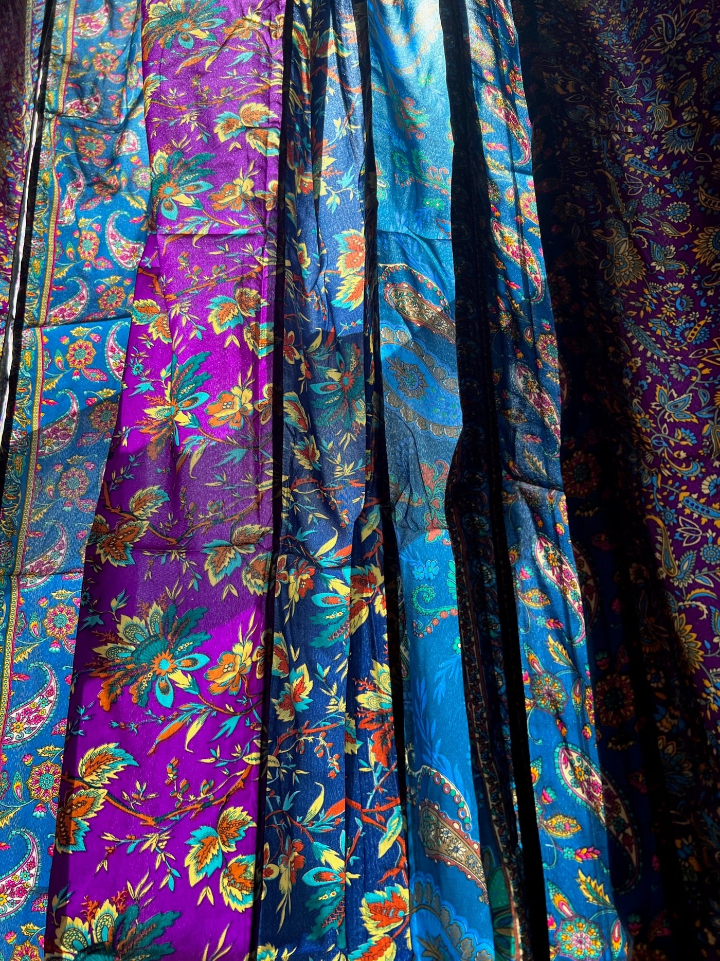 Detailed image of the beautiful floral patterns on the blue and purple sari silk curtain panels 