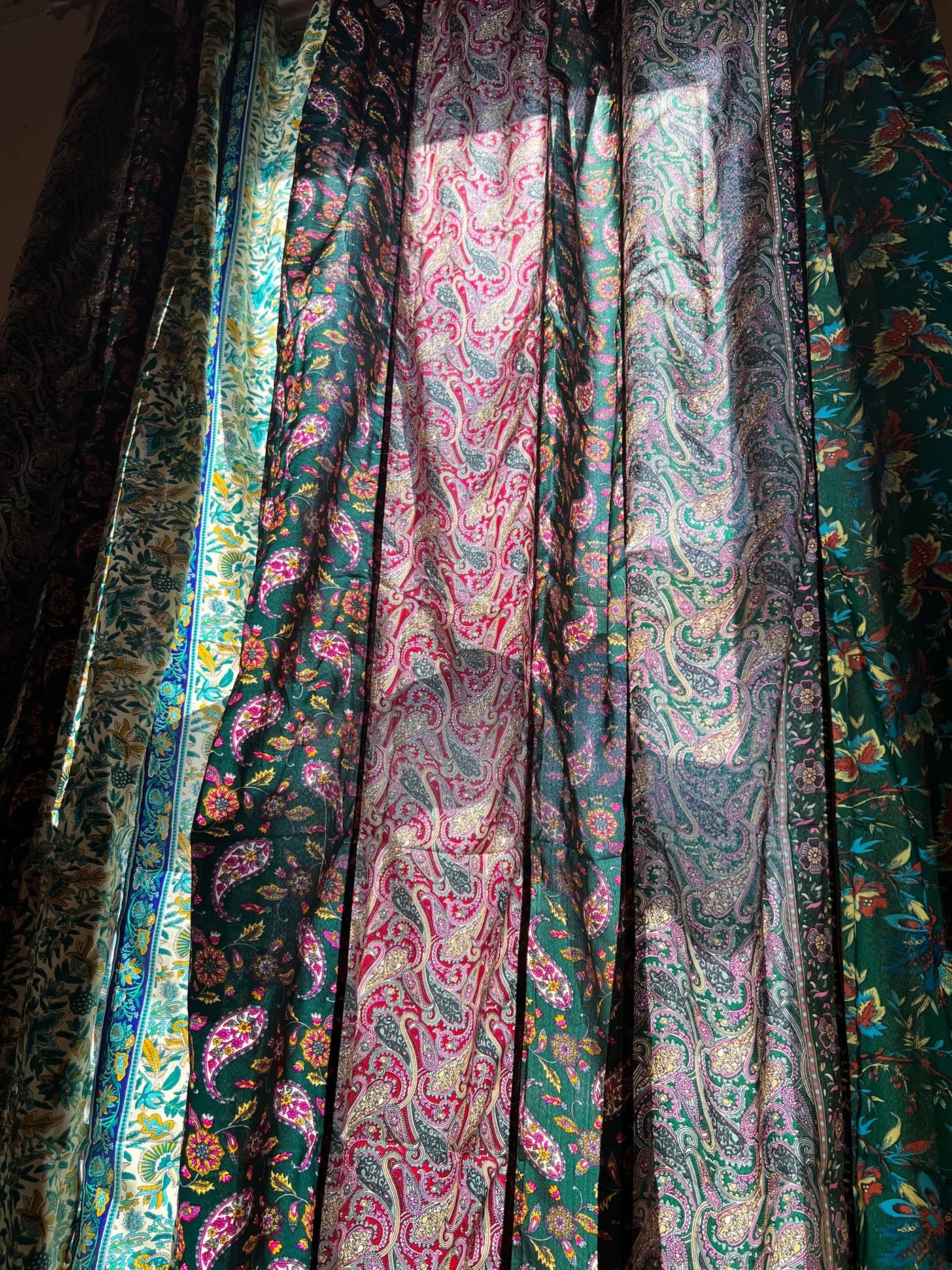 A close up image of sari silk curtains in green showcasing the beautiful and unique design