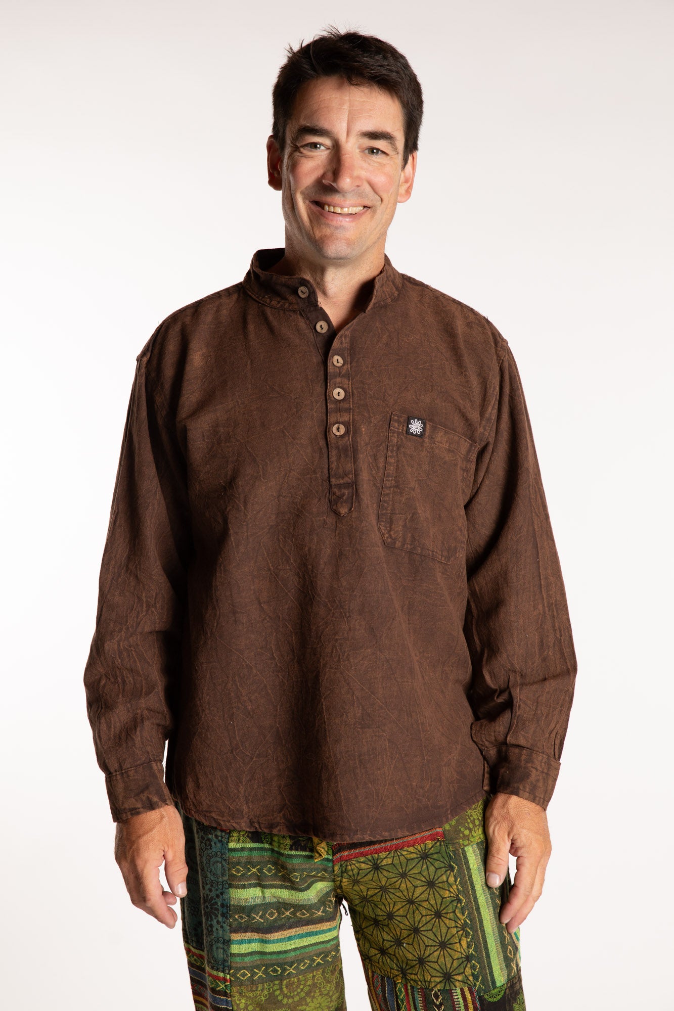 Topher is wearing the Brown Baje Stone Wash Henley Shirt in a Large