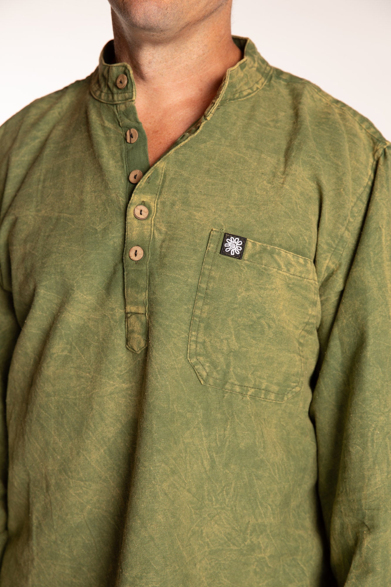 Topher is wearing the Green Baje Stone Wash Henley Shirt in a Large