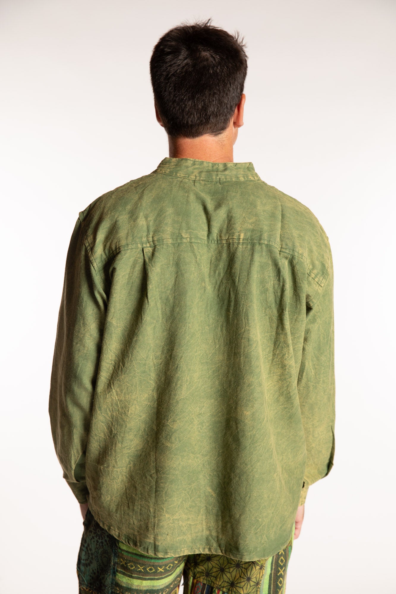 Topher is wearing the Green Baje Stone Wash Henley Shirt in a Large