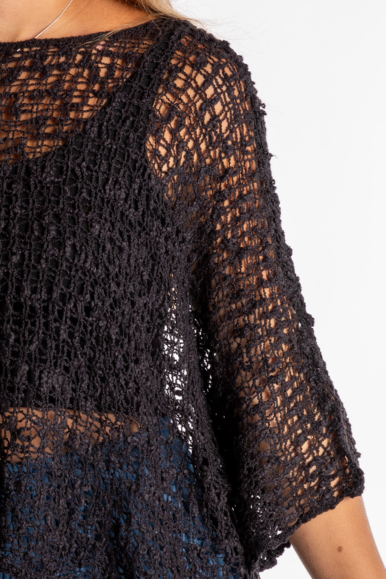 Sophie is wearing the Butterfly Lightweight Poncho in Black