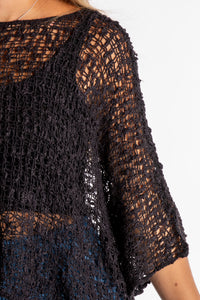 Sophie is wearing the Butterfly Lightweight Poncho in Black